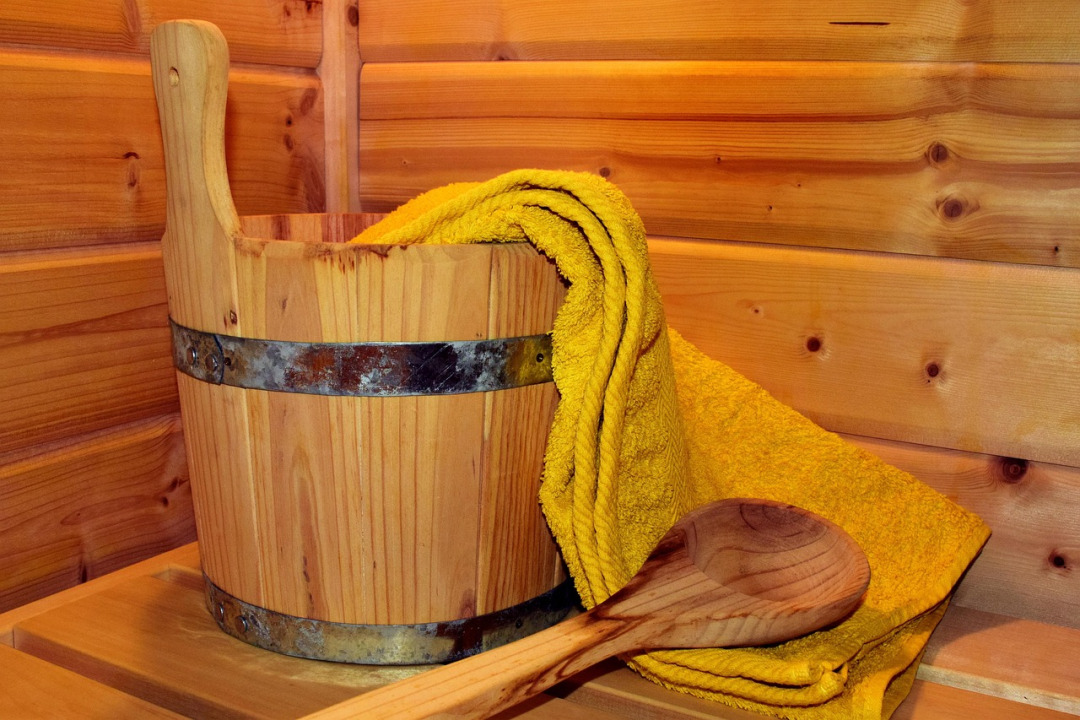 Warm wooden sauna interior with soft lighting, representing Russian spa traditions